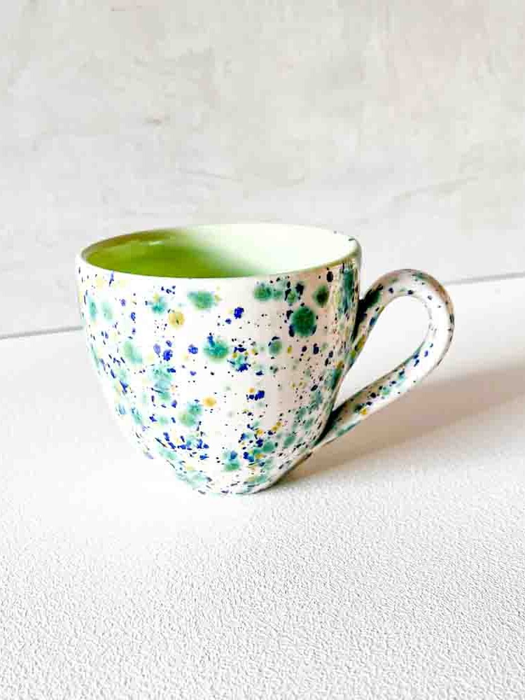 ceramic cup with handle in white with splash