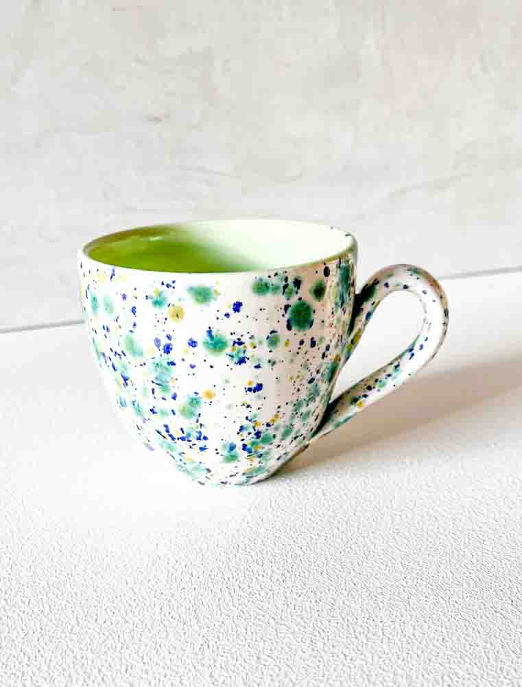 ceramic cup with handle in white with splash