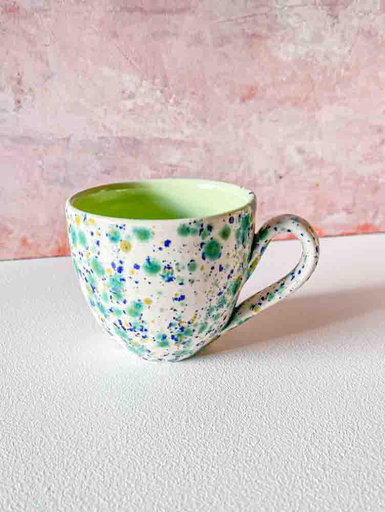 ceramic cup with handle in white with splash