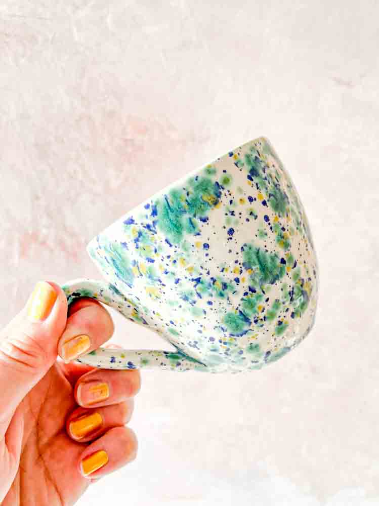 ceramic cup with handle in white with splash