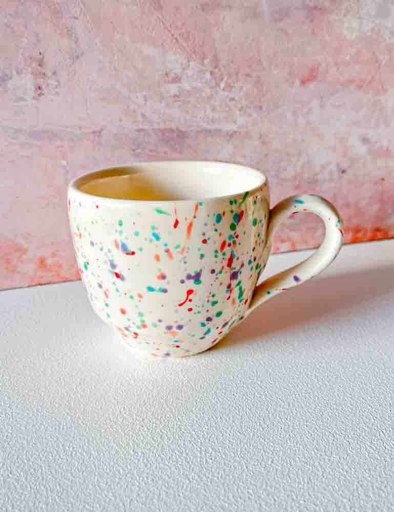 ceramic cup with handle in white with splash