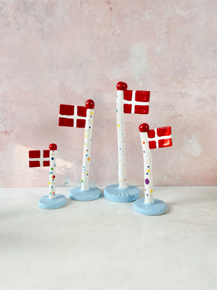 handmade ceramic flags from the clay play in harlequin flags with light blue feet.