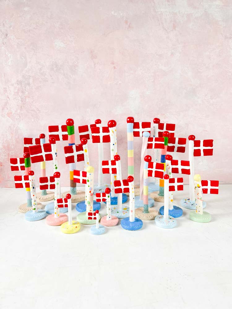 handmade ceramic flags from the clay play in harlequin flags with purple feet. Birthday flags - TheClayPlay