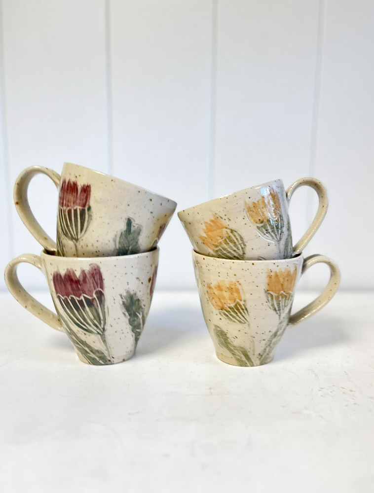 ceramic cup with handle and yellow flowers