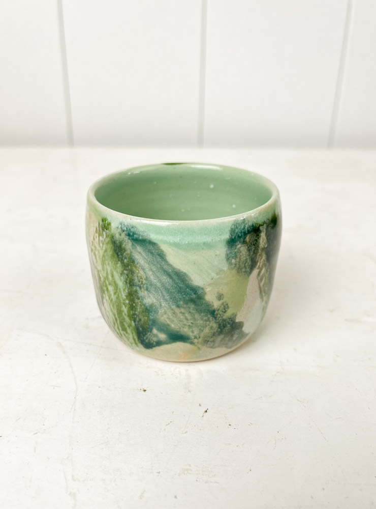 small ceramic mug without handle at the front