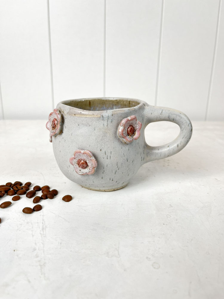 handmade ceramic cup with a handle and flowers in grey at Remix by Sofie in Copenhagen.