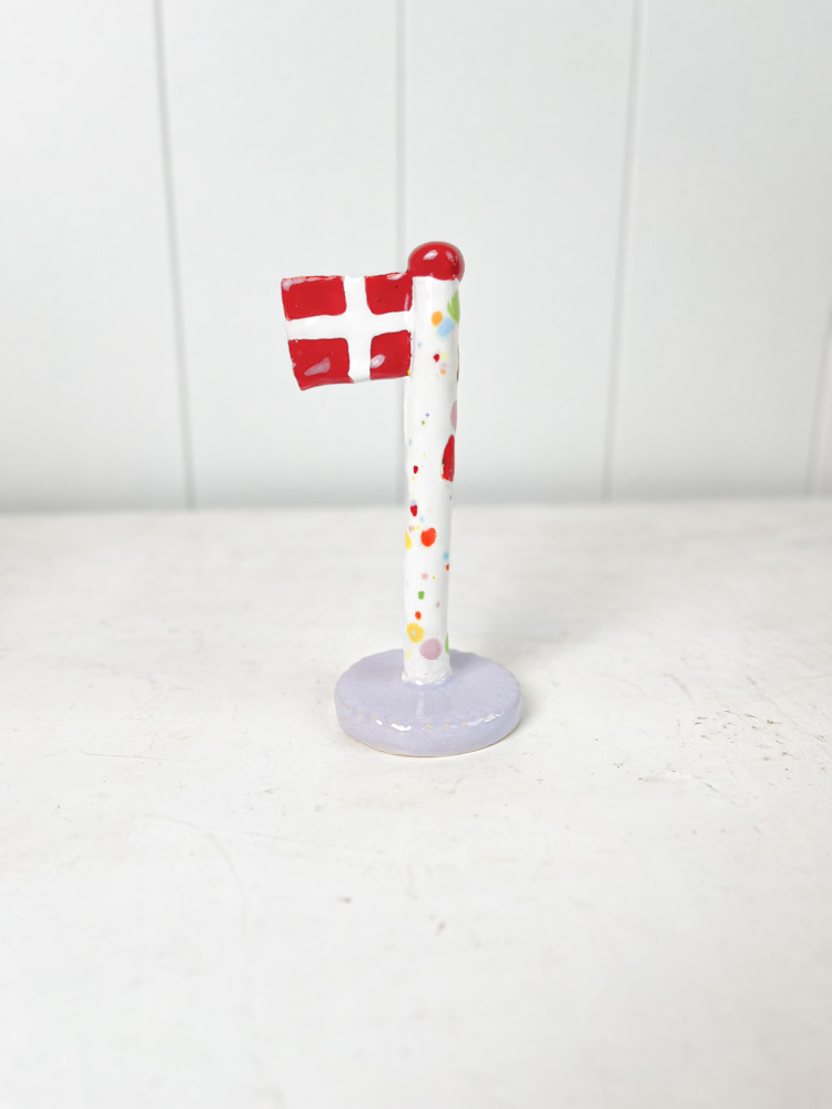 handmade ceramic flag from the clay play in harlequin flag with purple base