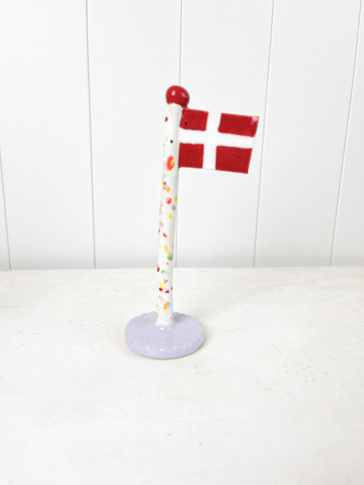 handmade ceramic flag from the clay play in harlequin flag with purple base